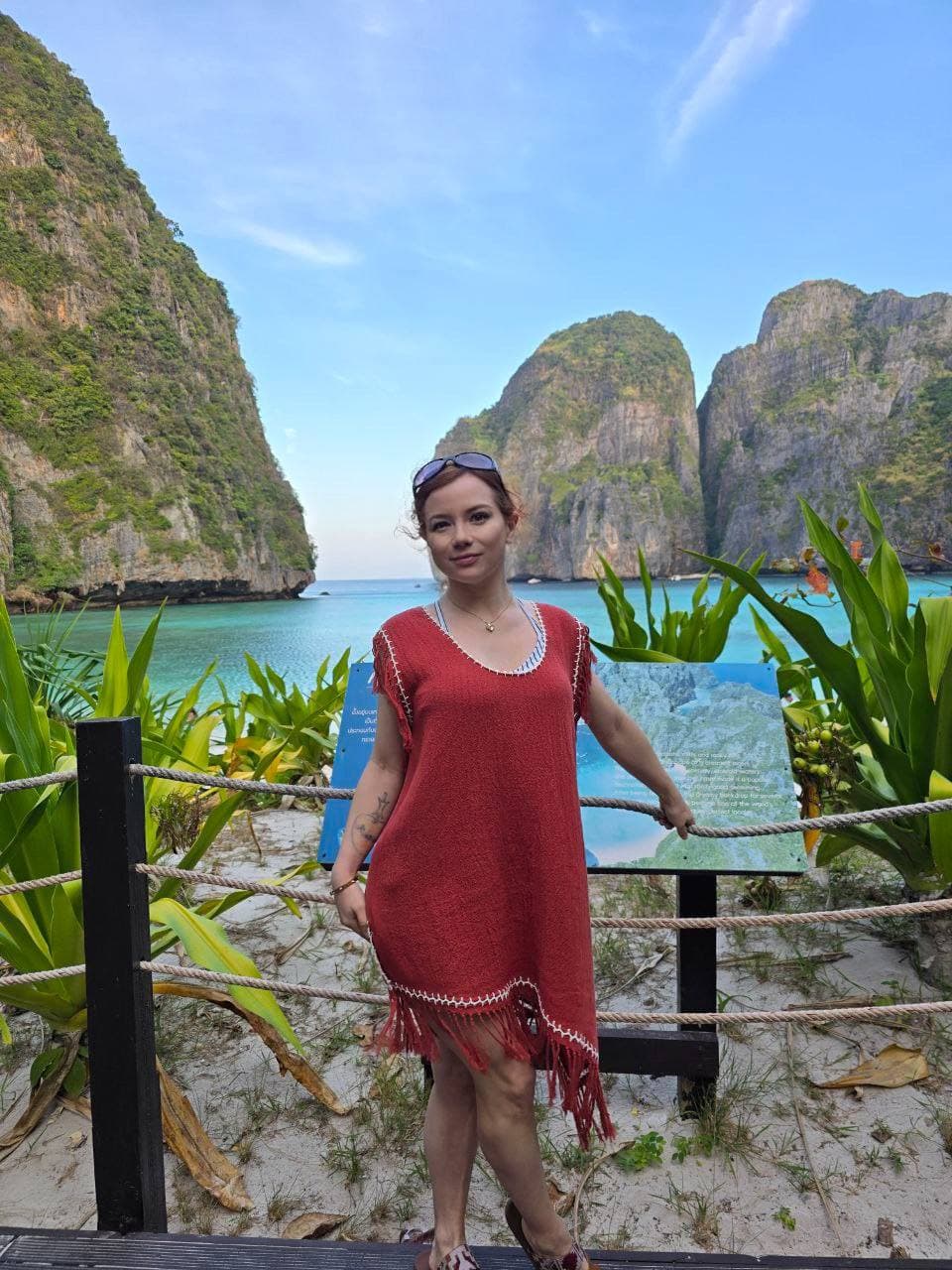 Alice Little overlooking a tropical bay while traveling
